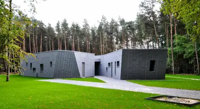 two modular buildings in a field with trees in the background at Twinstone Lodge in Genk
