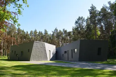 two modular buildings sitting on a grass field at Twinstone Lodge in Genk