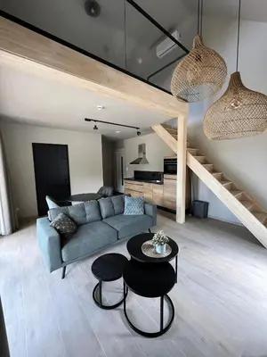 a living room with a couch and a table at Camping Natuurlijk Limburg - appartement 2p in Voeren