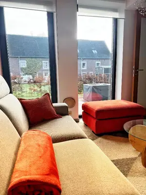 a living room with two couches and a large window at Le Chen Zen in Dalhem