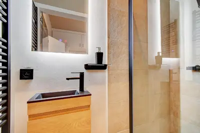 a bathroom with a sink and a shower at L'Escapade in Liège