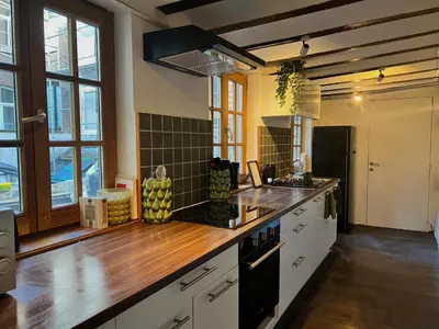 a kitchen with white cabinets and a counter top at Clémentine - 3 chambres en Hypercentre in Liège