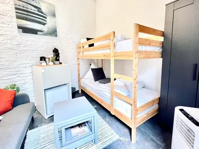 a room with a bunk bed and a couch at Casa Terraza in Hasselt