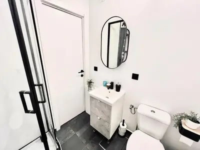 a white bathroom with a sink and a mirror at Casa Terraza in Hasselt