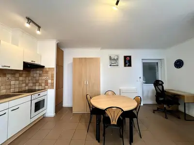 a kitchen and dining room with a table and chairs at Saint Leonard in Liège