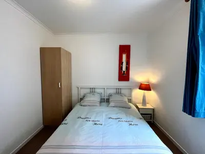 a bedroom with a bed and a red picture on the wall at Saint Leonard in Liège