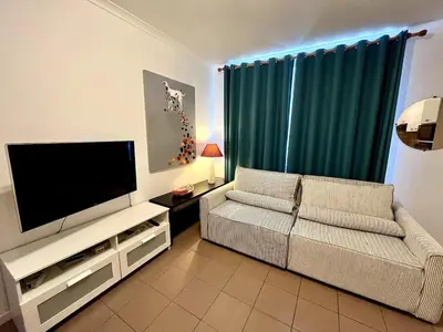 a living room with a couch and a flat screen tv at Saint Leonard in Liège