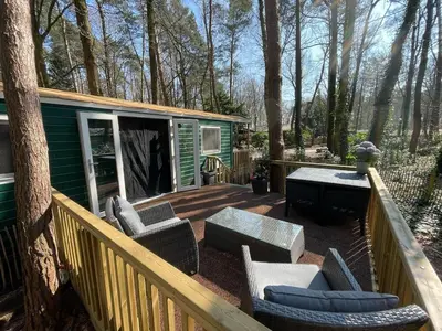 a deck with chairs and a table on a house at The Butterfly - Forest - Dog - Maastricht in Lanaken