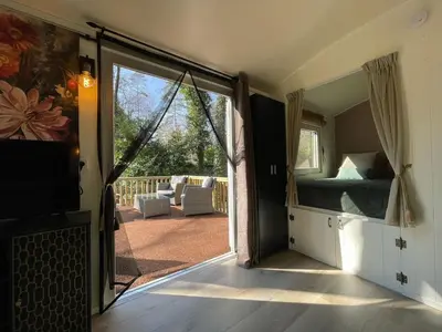 a room with a sliding glass door leading to a patio at The Butterfly - Forest - Dog - Maastricht in Lanaken