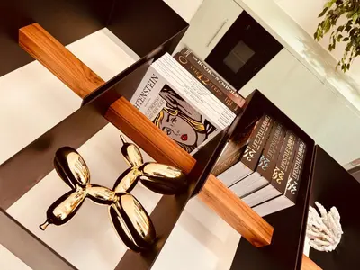 a table with a box of books and a pair of scissors at Secondo Piano Hasselt in Hasselt