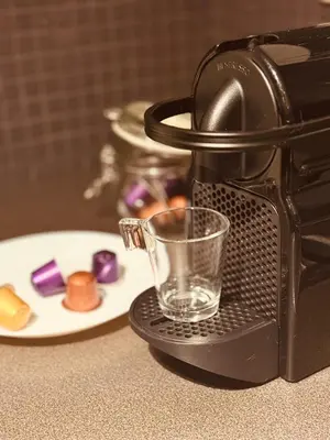 a coffee maker with a cup and a plate of food at Secondo Piano Hasselt in Hasselt