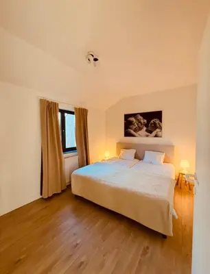 a bedroom with a large bed and a window at Secondo Piano Hasselt in Hasselt