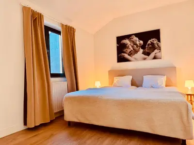 a bedroom with a bed and a window at Secondo Piano Hasselt in Hasselt