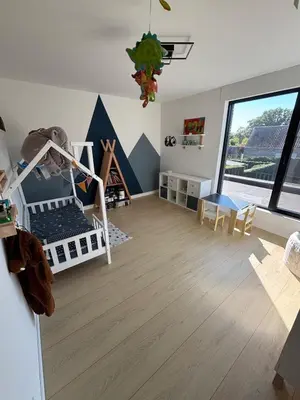 a room with a bedroom with a bunk bed and a table at Modern, child-friendly country house