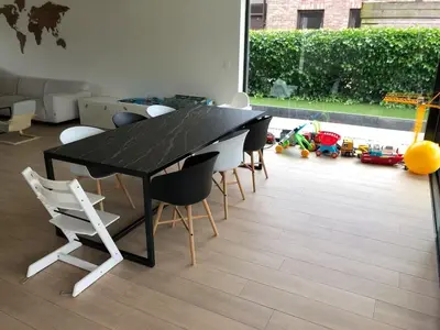 a dining room with a black table and chairs at Modern, child-friendly country house