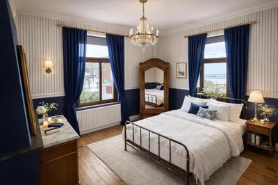 a bedroom with a bed with blue curtains and a mirror at Maison de Maître in Liège