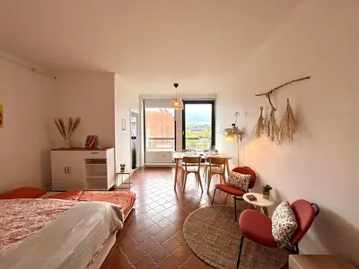 a bedroom with a bed and a table and chairs at Avenue Rogier in Liège