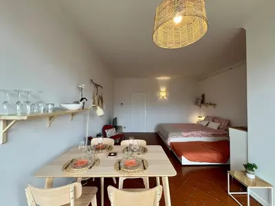 a room with a table with chairs and a bed at Avenue Rogier in Liège