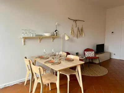 a dining room with a table with glasses and chairs at Avenue Rogier in Liège