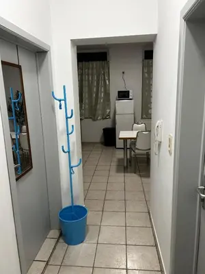 a hallway with a blue bucket in a room at Grâce à Liège in Grâce-Hollogne
