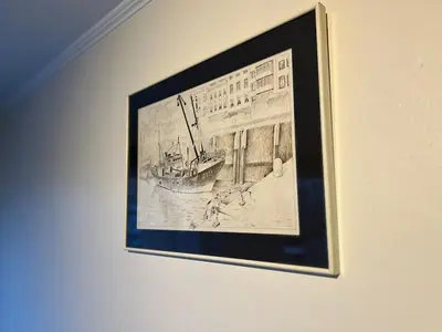a framed drawing of a building on a wall at Le studio de la Boverie - Entièrement équipé in Liège