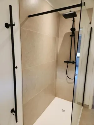 a shower with a glass door in a bathroom at Verliefd in Brustem in Sint-Truiden