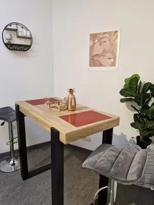 a wooden table in a room with a chair at Cocon Liégeois in Liège