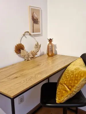 a wooden desk with a pillow on a chair at Cocon Liégeois in Liège