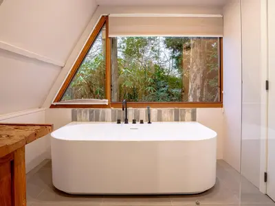 a bath tub in a bathroom with a window at Boshuisje Rekem - Sylva in Lanaken