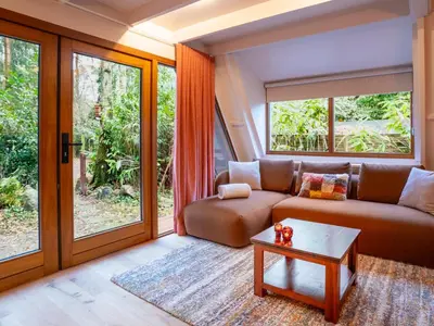 a living room with a couch and a table at Boshuisje Rekem - Sylva in Lanaken