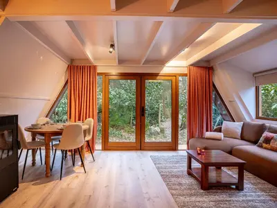 a living room with a couch and a table at Boshuisje Rekem - Sylva in Lanaken