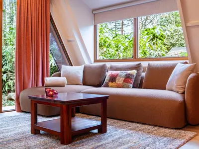 a living room with a couch and a table at Boshuisje Rekem - Sylva in Lanaken