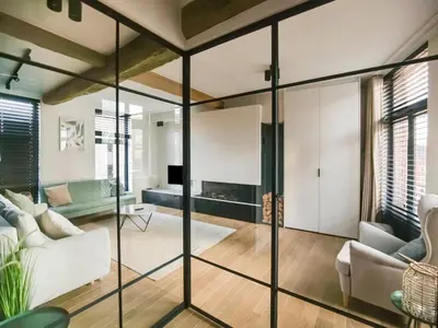 a room with glass walls and a living room at Holiday home in the heart of Hasselt in Hasselt