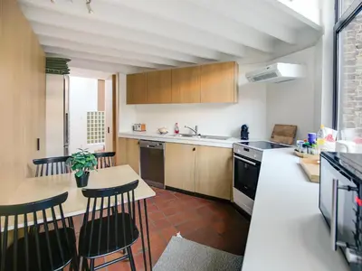a kitchen with a table and chairs and a counter top at Holiday home in the heart of Hasselt in Hasselt