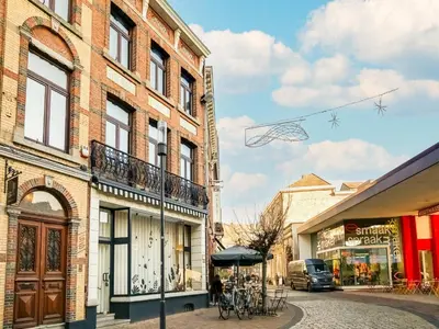 a kite flying in the sky over a street at Holiday home in the heart of Hasselt in Hasselt