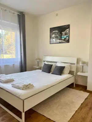 a bedroom with a large white bed with blue pillows at Vintage Station in Ans