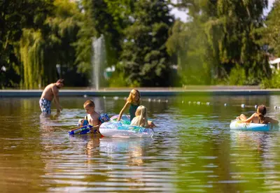 a group of people floating on tubes in the water at Camping Papillon Kinrooi - Vakantiehuis Premium 4P in Kinrooi