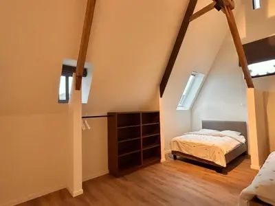 a bedroom with a bed in a attic at Spacious 3-Floor Holiday Home for 8 Guests in Bree