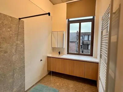 a bathroom with a sink and a window at Spacious 3-Floor Holiday Home for 8 Guests in Bree