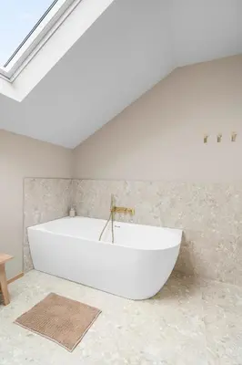 a large white bath tub in a bathroom at De Kompanie in Alken