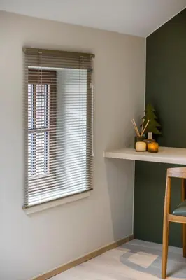 a window in a room with a table and a shelf at De Kompanie in Alken