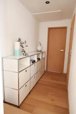 a white dresser in a room with a door at Homestorys Nature Resort - Wood Lounge in Eupen
