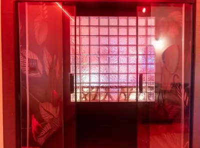 a glass door with a window in a room at Temple Torii in Crisnée