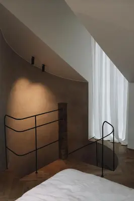 a bedroom with a bed in a room with a roof at number nine house in Hasselt