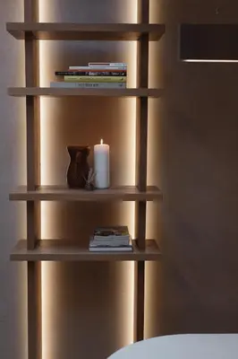 a book shelf with a candle and books at number nine house in Hasselt