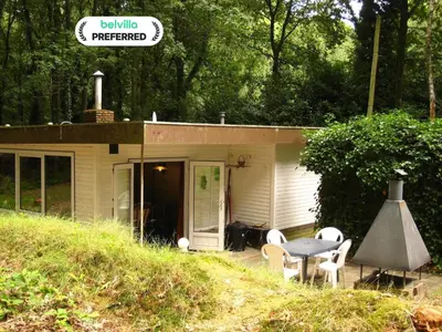 a small house with a table and chairs in front of it at Lanklaar Chalet with Garden in Lanklaar