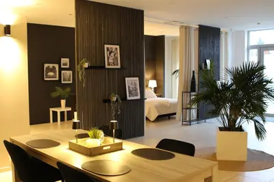 a living room with a table and a bedroom at Casa Verde in Maasmechelen