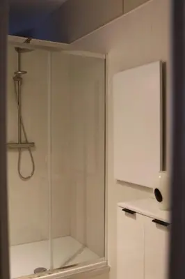 a shower with a glass door in a bathroom at Casa Verde in Maasmechelen