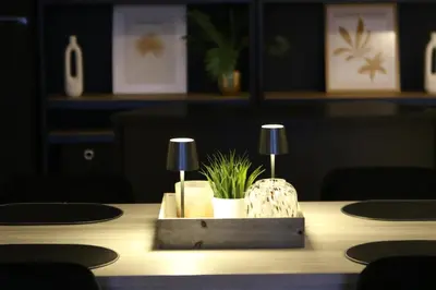 a table with two lamps and a plant on it at Casa Verde in Maasmechelen