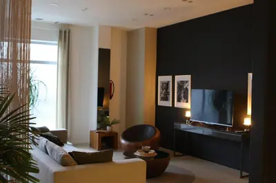 a living room with a couch and a television at Casa Verde in Maasmechelen